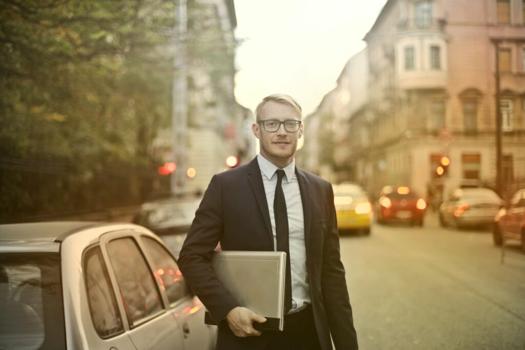 CEO holding his files in the street. scaled