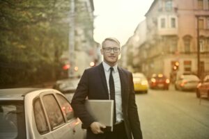 CEO-holding-his-files-in-the-street. CEO-holding-his-files-in-the-street.