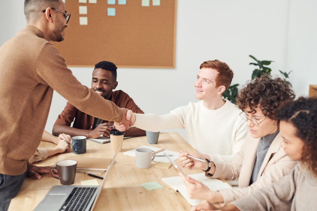 Coworkers discussing ways to find the best company to develop their product